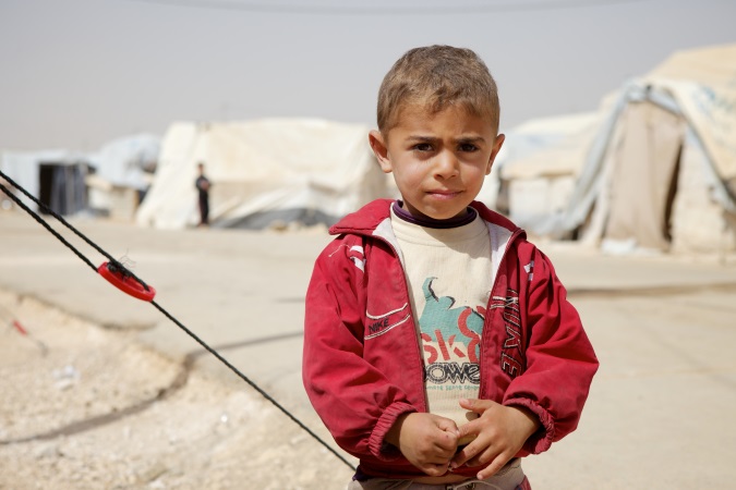 Ahmed (5) from the southern Syrian city of Daara outside his tent in Zaatari refugee camp.