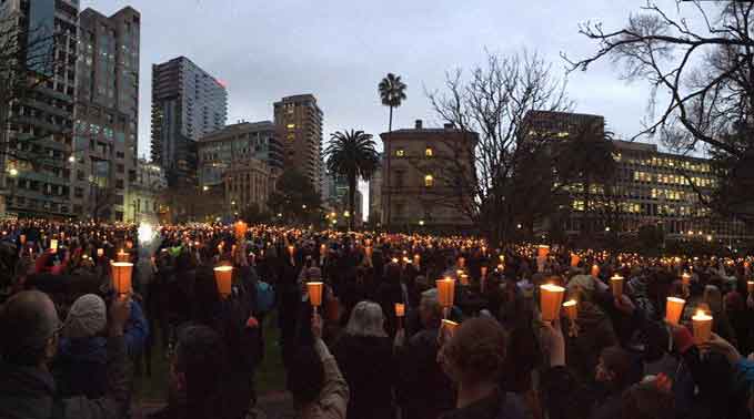 crowd holding candles at Light the Dark