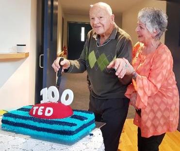 Ted Howe cuts his birthday cake with a little help from daughter Susan Grist